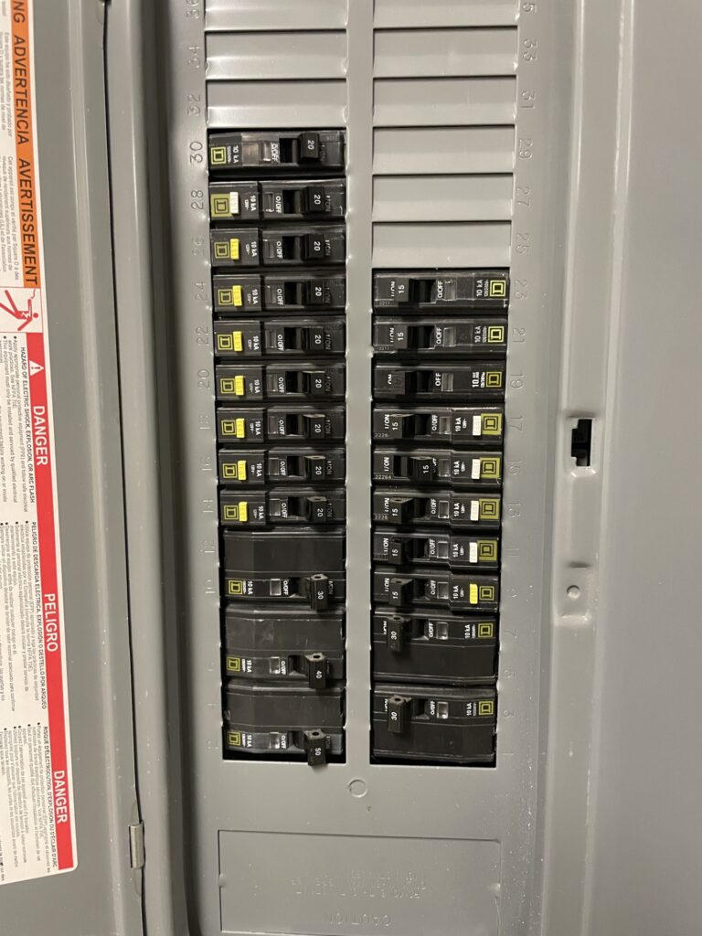 Square D breaker panel interior with organized 20A / 30A / 40A / 50A circuits