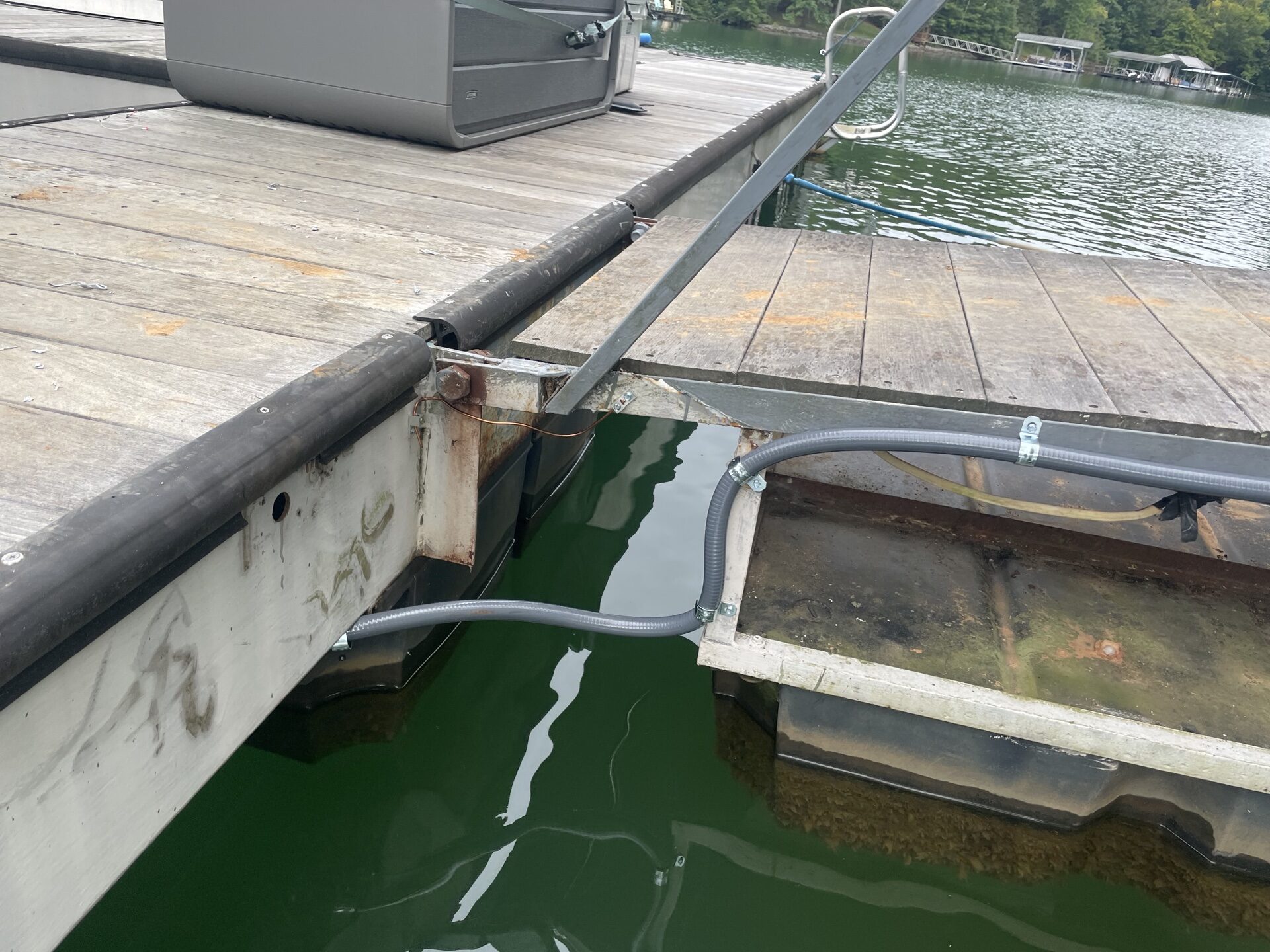 Clean conduit run under lake dock with proper cable support